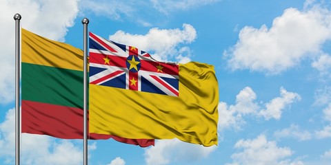Lithuania and Niue flag waving in the wind against white cloudy blue sky together. Diplomacy concept, international relations.