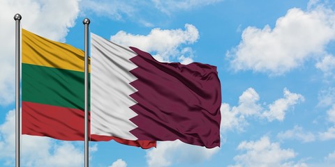 Lithuania and Qatar flag waving in the wind against white cloudy blue sky together. Diplomacy concept, international relations.