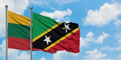 Lithuania and Saint Kitts And Nevis flag waving in the wind against white cloudy blue sky together. Diplomacy concept, international relations.