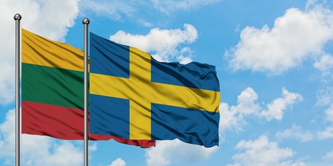 Lithuania and Sweden flag waving in the wind against white cloudy blue sky together. Diplomacy concept, international relations.