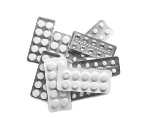 Blister packs with different pills on white background