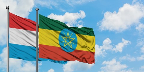 Luxembourg and Ethiopia flag waving in the wind against white cloudy blue sky together. Diplomacy concept, international relations.