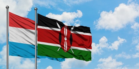 Luxembourg and Kenya flag waving in the wind against white cloudy blue sky together. Diplomacy concept, international relations.