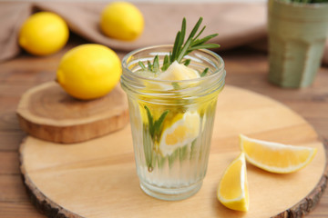 Glass of fresh lemonade on table