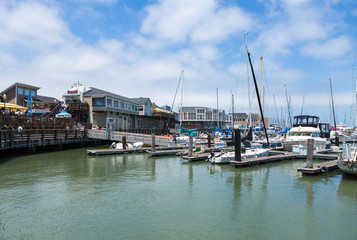 Fototapeta na wymiar SAN FRANCISCO, USA - JUNE 14: Pier 39 at San Francisco Bay, on JUNE 14, 2015. Pier 39 was first developed by entrepreneur Warren Simmons and opened October 4, 1978