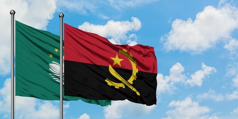 Macao and Angola flag waving in the wind against white cloudy blue sky together. Diplomacy concept, international relations.