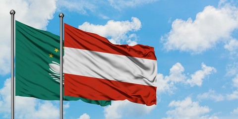 Macao and Austria flag waving in the wind against white cloudy blue sky together. Diplomacy concept, international relations.