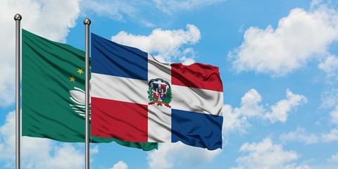Macao and Dominican Republic flag waving in the wind against white cloudy blue sky together. Diplomacy concept, international relations.