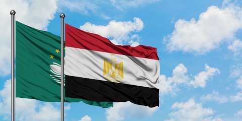 Macao and Egypt flag waving in the wind against white cloudy blue sky together. Diplomacy concept, international relations.
