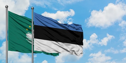 Macao and Estonia flag waving in the wind against white cloudy blue sky together. Diplomacy concept, international relations.