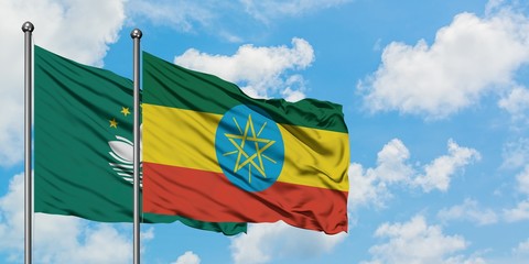 Macao and Ethiopia flag waving in the wind against white cloudy blue sky together. Diplomacy concept, international relations.