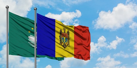 Macao and Moldova flag waving in the wind against white cloudy blue sky together. Diplomacy concept, international relations.