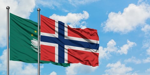 Macao and Norway flag waving in the wind against white cloudy blue sky together. Diplomacy concept, international relations.