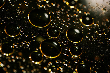 Golden oil bubbles macro on water black background with bokeh fifty megapixels prints