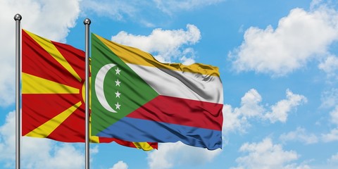 Macedonia and Comoros flag waving in the wind against white cloudy blue sky together. Diplomacy concept, international relations.