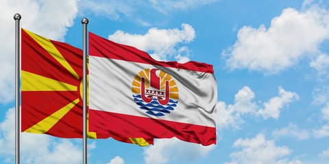 Macedonia and French Polynesia flag waving in the wind against white cloudy blue sky together. Diplomacy concept, international relations.