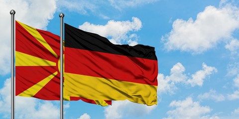 Macedonia and Germany flag waving in the wind against white cloudy blue sky together. Diplomacy concept, international relations.