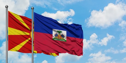 Macedonia and Haiti flag waving in the wind against white cloudy blue sky together. Diplomacy concept, international relations.