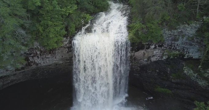 Aerial footage flying above and towards the beautiful and gushing Foster Falls, Tennessee.