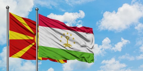 Macedonia and Tajikistan flag waving in the wind against white cloudy blue sky together. Diplomacy concept, international relations.