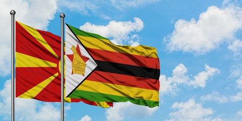 Macedonia and Zimbabwe flag waving in the wind against white cloudy blue sky together. Diplomacy concept, international relations.