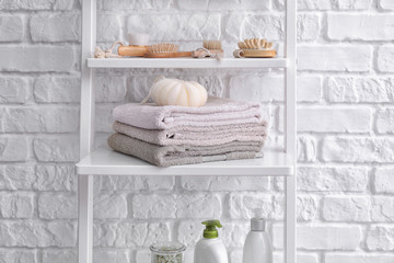 Fototapeta na wymiar Stack of towels on shelf in bathroom