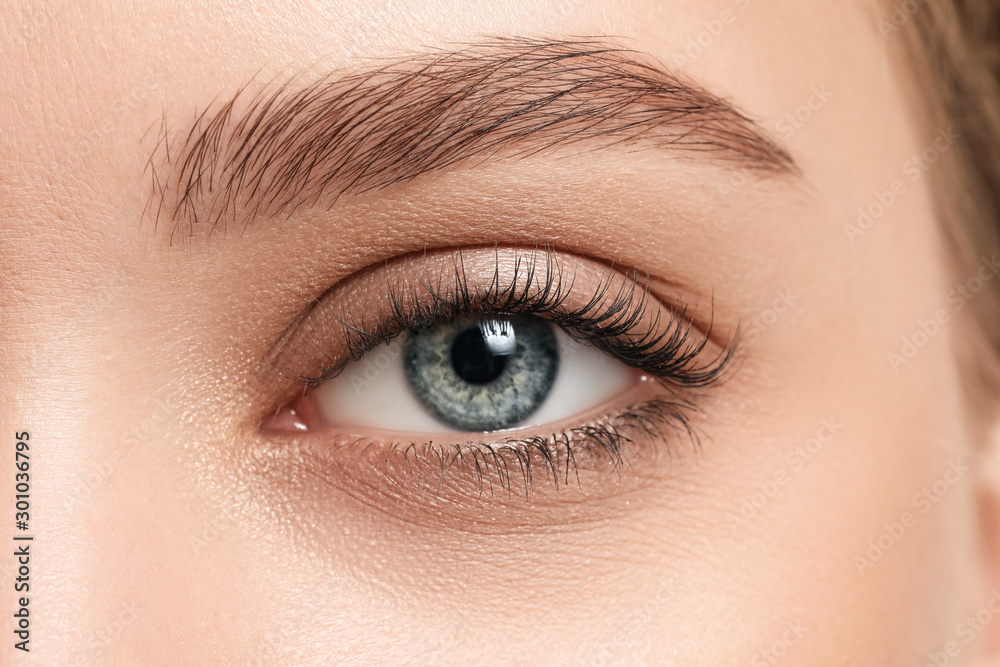 Young woman with beautiful eyebrows, close-up (Adobe Stock comp)
