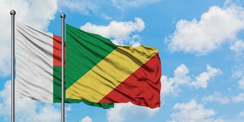 Madagascar and Republic Of The Congo flag waving in the wind against white cloudy blue sky together. Diplomacy concept, international relations.