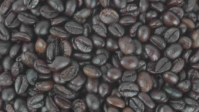 Close up Move the camera angle from top to bottom, Many roasted coffee beans background, Food concept Top view. 