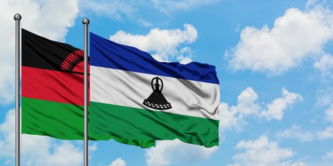 Malawi and Lesotho flag waving in the wind against white cloudy blue sky together. Diplomacy concept, international relations.