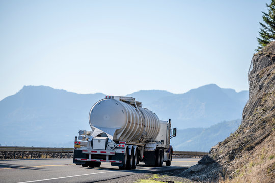 Big Rig Semi Truck With Tank Semi Trailer For Transportation Of Liquid Chemical And Explosive Substances Driving On The Road In Columbia Gorge