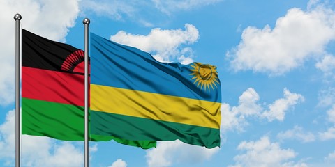 Malawi and Rwanda flag waving in the wind against white cloudy blue sky together. Diplomacy concept, international relations.