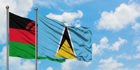 Malawi and Saint Lucia flag waving in the wind against white cloudy blue sky together. Diplomacy concept, international relations.