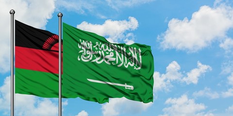 Malawi and Saudi Arabia flag waving in the wind against white cloudy blue sky together. Diplomacy concept, international relations.
