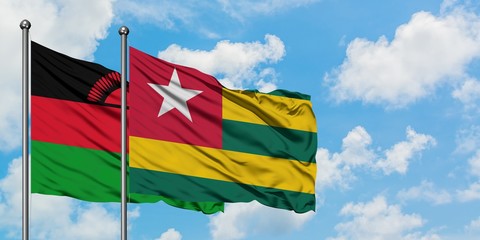 Malawi and Togo flag waving in the wind against white cloudy blue sky together. Diplomacy concept, international relations.
