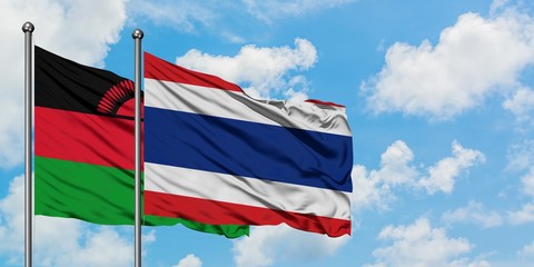 Malawi and Thailand flag waving in the wind against white cloudy blue sky together. Diplomacy concept, international relations.