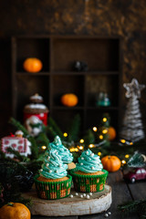 Citrus cupcakes with butter cream and festive decor for New Year and Christmas.