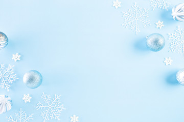 Christmas background concept. Top view of Christmas ball with snowflakes on light blue pastel background.