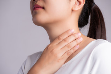 Sore Throat. Closeup Of Beautiful Young Woman Hand Touching Her Ill Neck. Healthcare and medical...