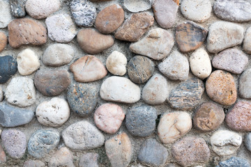 The wall is made of stone in many colors.