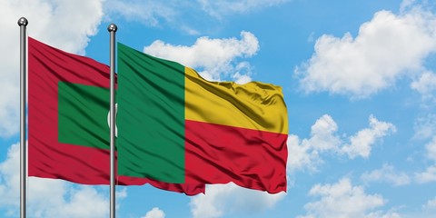 Maldives and Benin flag waving in the wind against white cloudy blue sky together. Diplomacy concept, international relations.