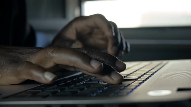 Black business man Working Late At Night Typing,close up