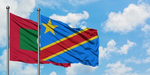 Maldives and Congo flag waving in the wind against white cloudy blue sky together. Diplomacy concept, international relations.