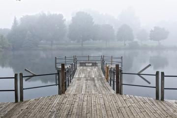 symmetrical walkway in the fog over the water