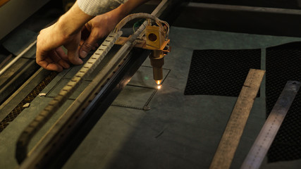 Laser cutting beam artificial leather High precision. Modern machine industrial technology of artificial leather cutting. CNC laser. Masterclass, workshop session