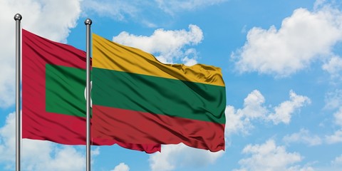 Maldives and Lithuania flag waving in the wind against white cloudy blue sky together. Diplomacy concept, international relations.