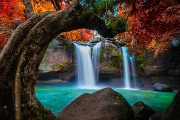 Fototapete The amazing colorful waterfall in autumn forest blue water and colorful rain forest. © APchanel