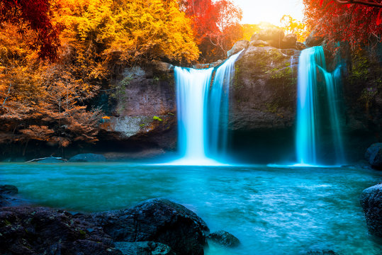 The amazing colorful waterfall in autumn forest blue water and colorful rain forest. © APchanel