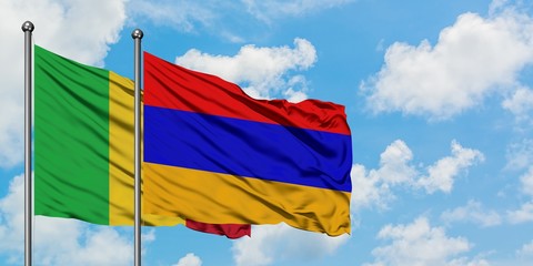 Mali and Armenia flag waving in the wind against white cloudy blue sky together. Diplomacy concept, international relations.