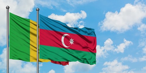 Mali and Azerbaijan flag waving in the wind against white cloudy blue sky together. Diplomacy concept, international relations.